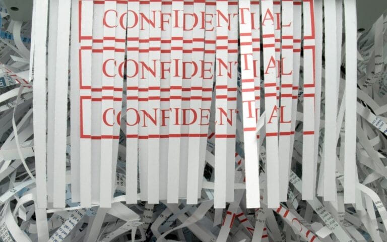 Shredded paper with 'Confidential' text visible