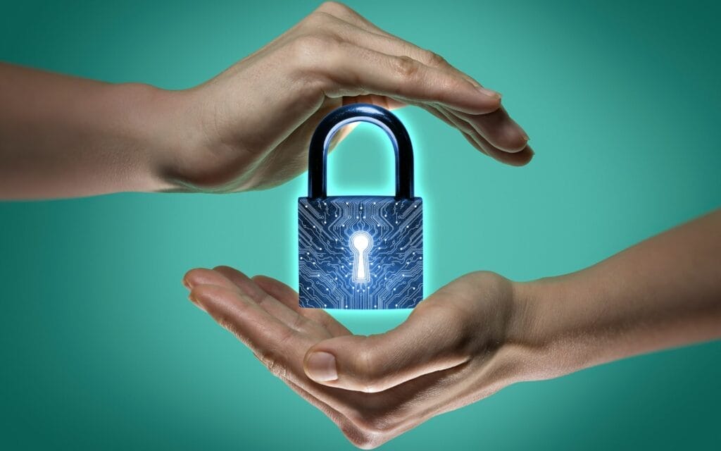 Hands protecting digital lock symbolizing cybersecurity.