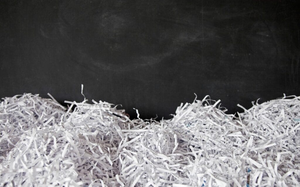 Shredded paper in front of blackboard background