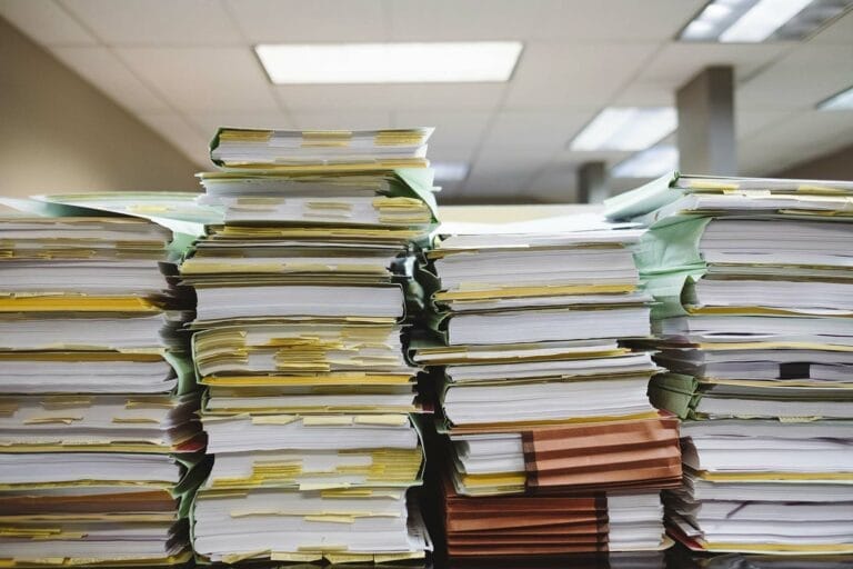 Stacks of organized paper folders and documents