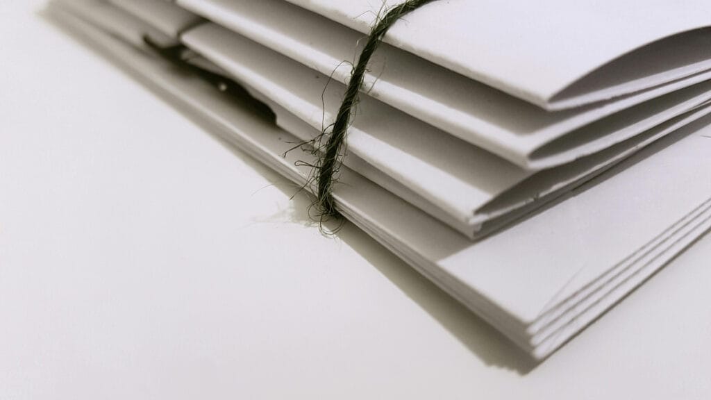 Stack of white envelopes tied with string
