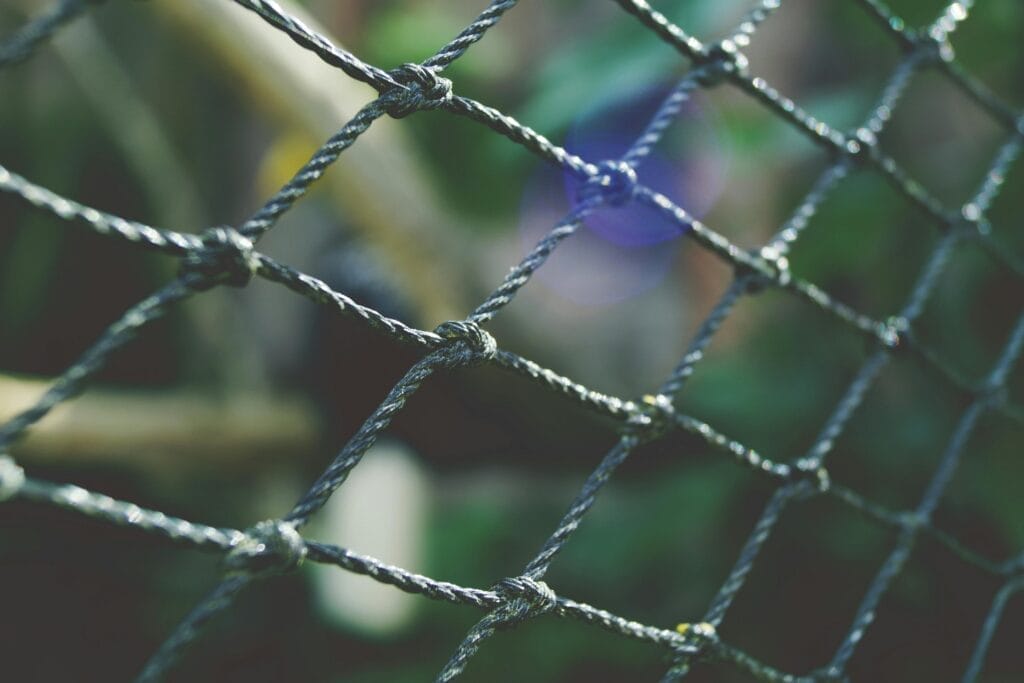 Close-up of a wire fence outdoors.