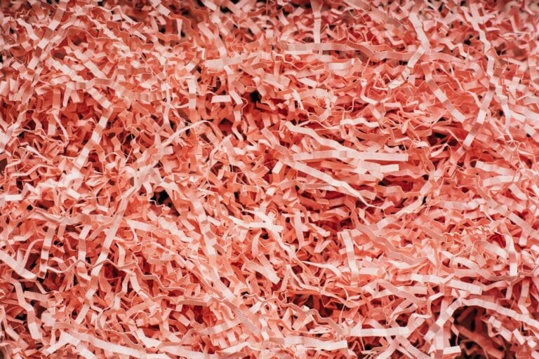 Pile of shredded pink paper strips.