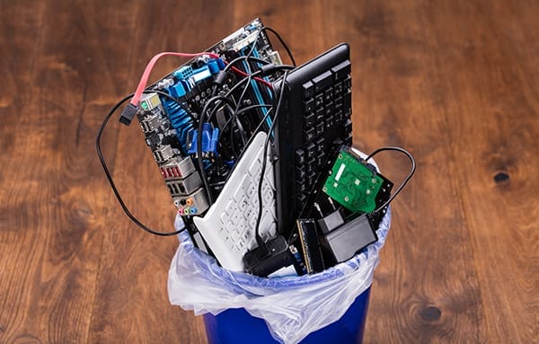 Electronic waste in a trash can, recycling concept.
