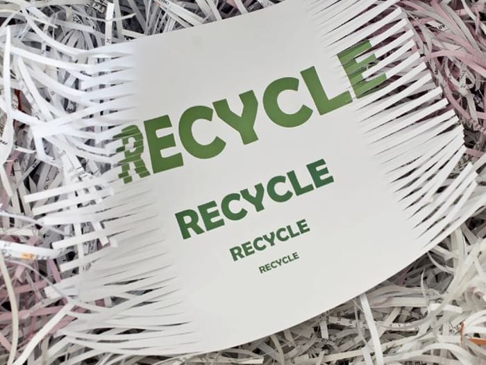 Shredded paper with recycle message