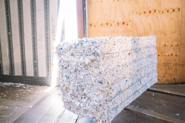 Baled shredded paper in a loading dock area.
