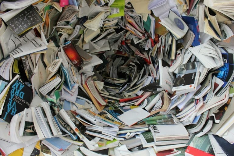Vortex of scattered open books and magazines.