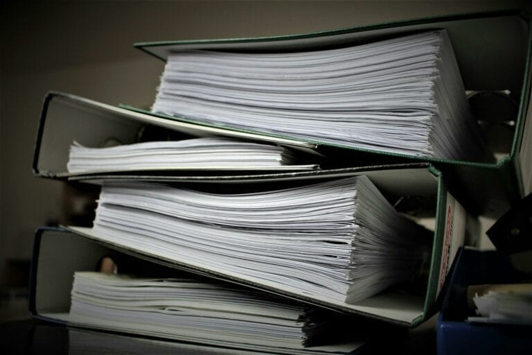 Stack of full green file binders