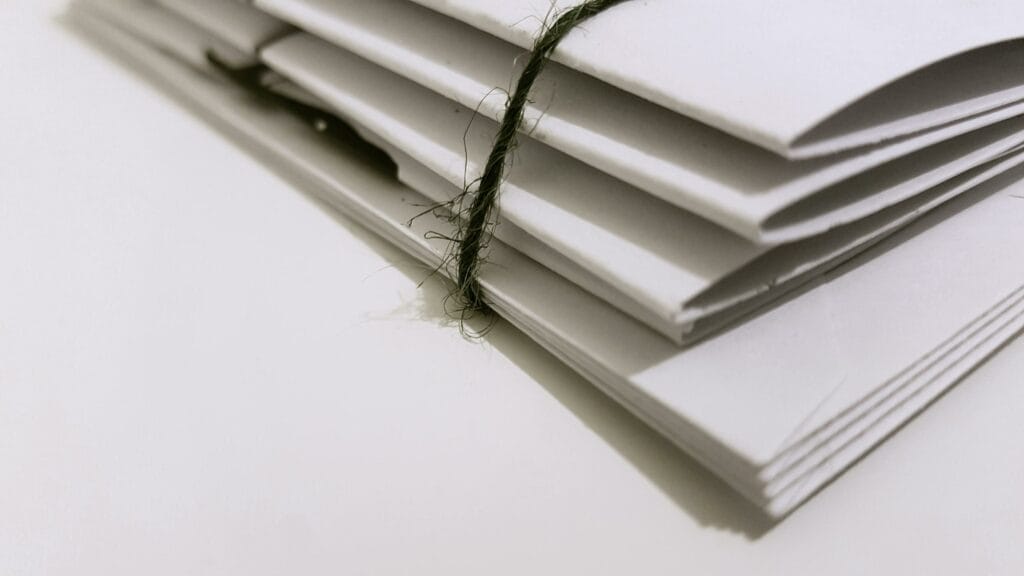 Stack of tied white envelopes