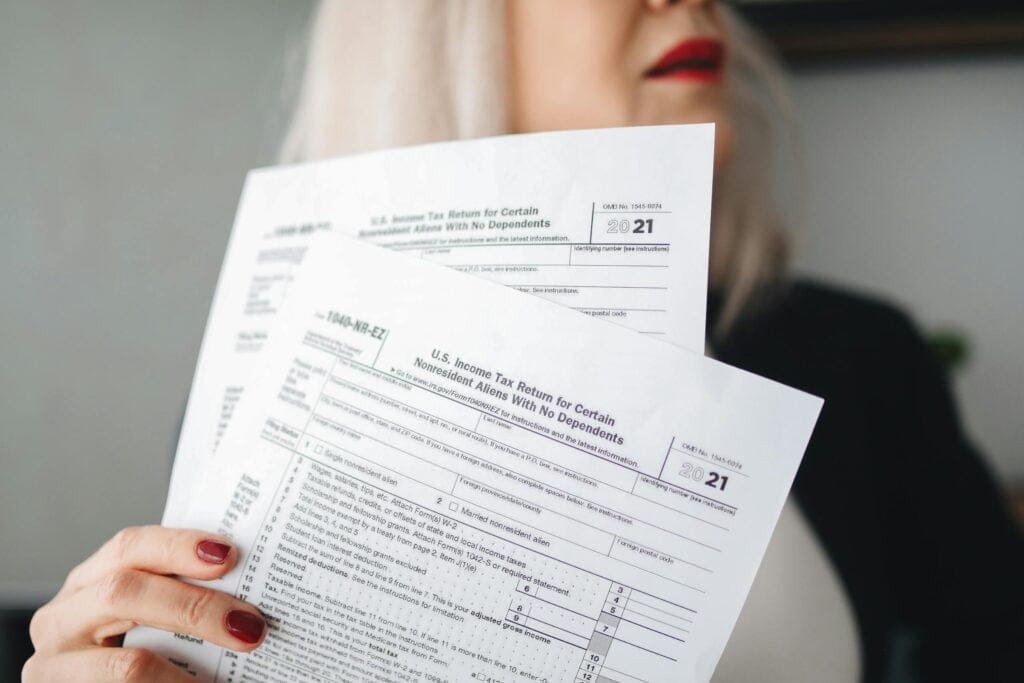 Person holding tax forms for 2021