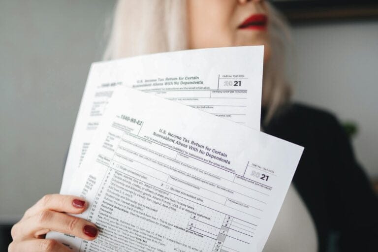 Person holding tax forms for 2021