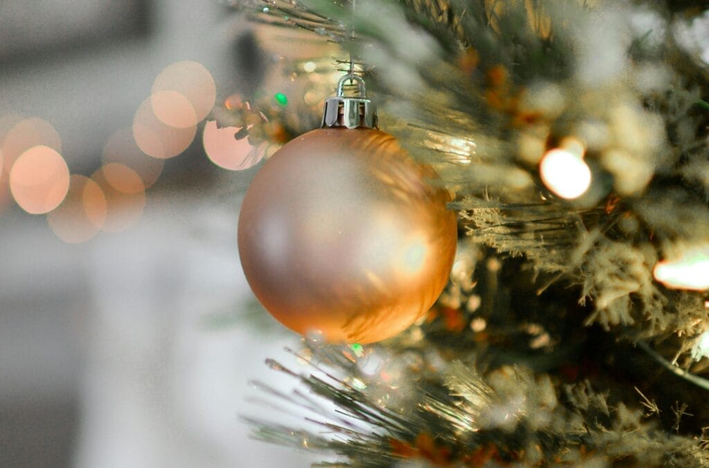 Golden Christmas ornament hanging on tree