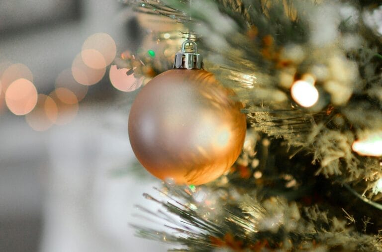 Golden Christmas ornament hanging on tree