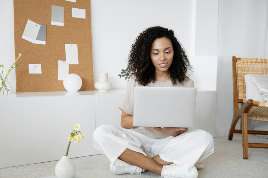 Woman sitting with laptop, modern interior design.