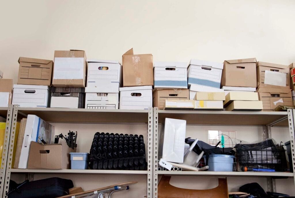 Storage shelves stacked with boxes and miscellaneous items.